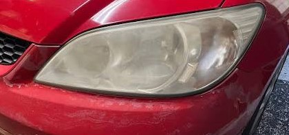 Red car headlight restoration - before